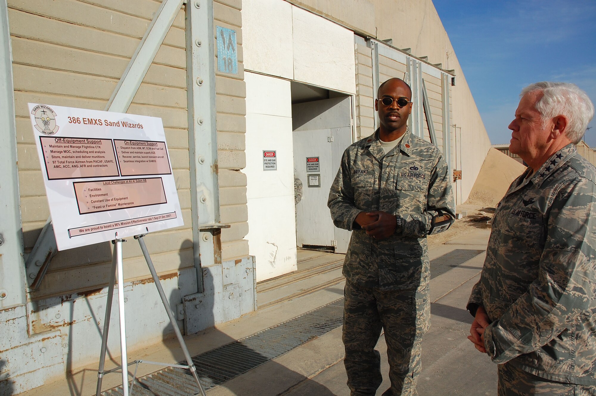 SOUTHWEST ASIA -- Gen. Arthur J. Lichte receives a mission brief from Maj. Emille Bryant, 386th Expeditionary Maintenance Squadron commander, here Jan. 7.  General Lichte, commander of Air Mobility Command, was making his first visit downrange since taking command in September.  (U.S. Air Force photo/Staff Sgt. Tia Schroeder)  
