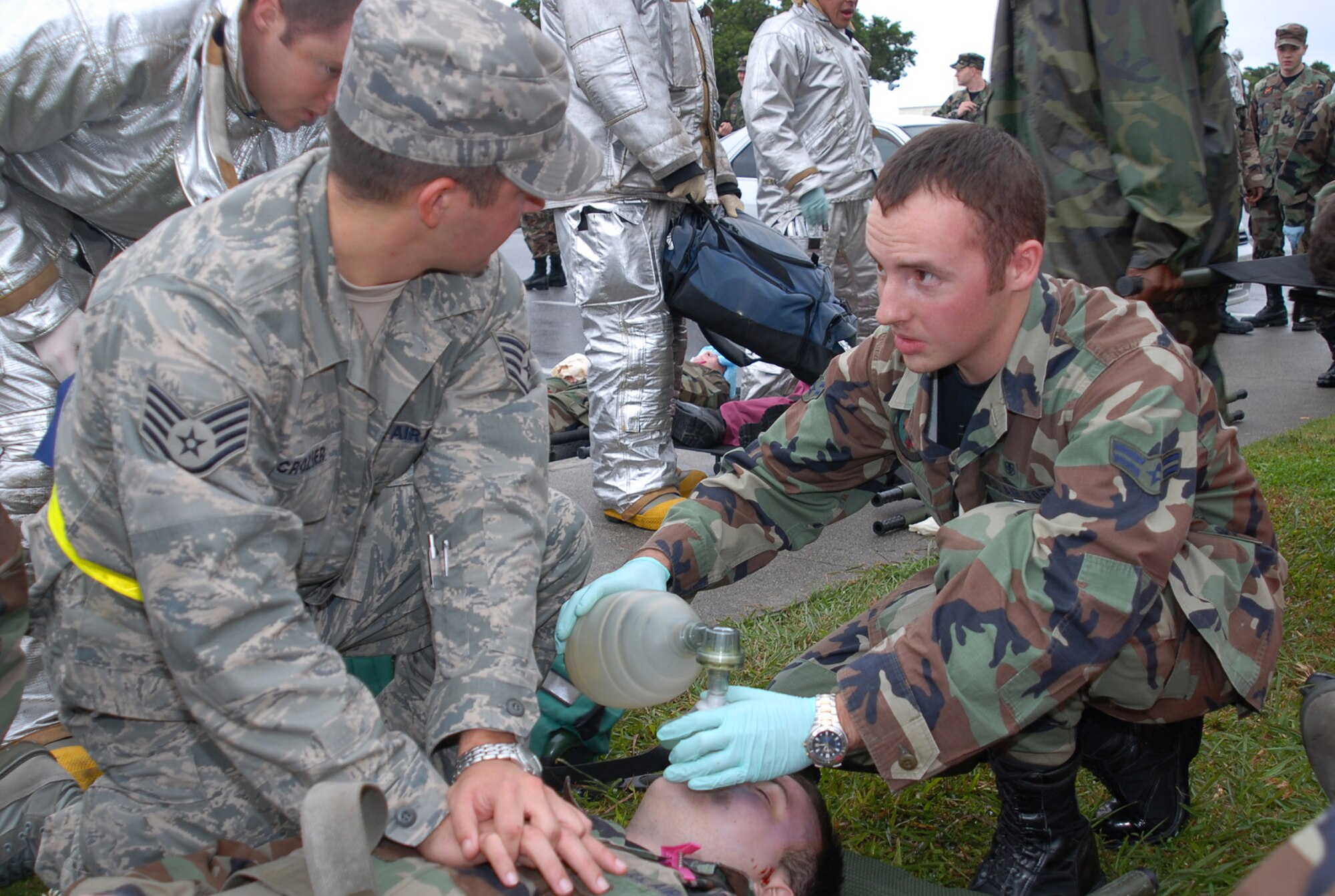 Staff Sgt. Michael Crozier, 18th Communications Squadron, and Airman First Class Michael Stull, 18th Aerospace Medical Squadron, perform CPR on a victim following a simulated explosion of the Marshall Dining Facility during Local Operational Readiness Exercise Beverly High at Kadena Air Base, Japan, Jan. 7, 2007. The 18th Wing exercise from Jan. 7 to 11 tests the wing's ability to respond in contingency situations.   (U.S. Air Force photo/Tech. Sgt. Dave DeRemer)