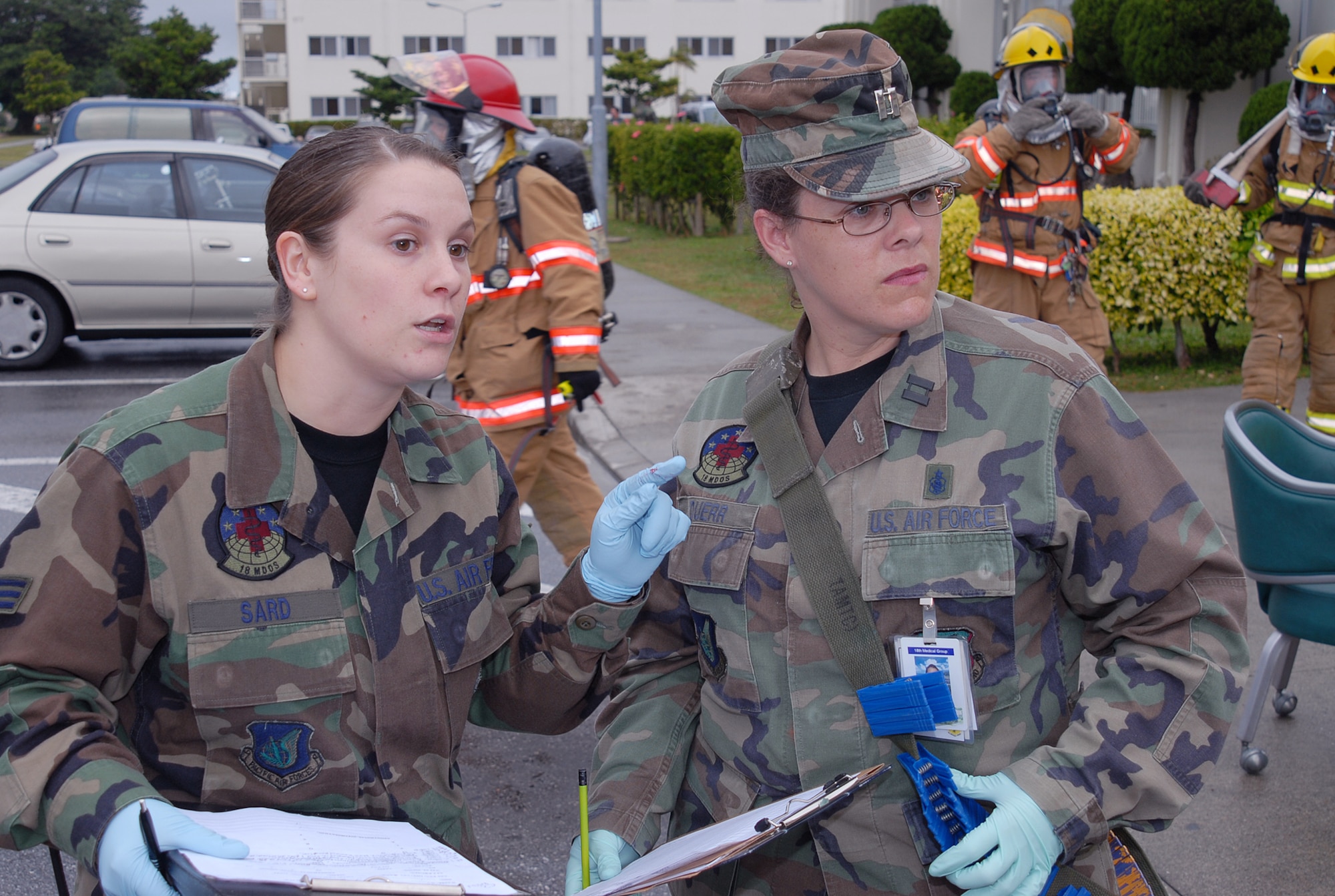 Senior Airman Ashley Sard, 18th Medical Operations Squadron, reports victim information to Captain Dana Duerr, 18th Aerospace Medical Squadron, following a simulated explosion of the Marshall Dining Facility during Local Operational Readiness Exercise Beverly High 08-3 at Kadena Air Base, Japan, Jan. 7, 2007. The 18th Wing exercise from Jan. 7 to 11 tests the wing's ability to respond in contingency situations.   (U.S. Air Force photo/Tech. Sgt. Dave DeRemer)