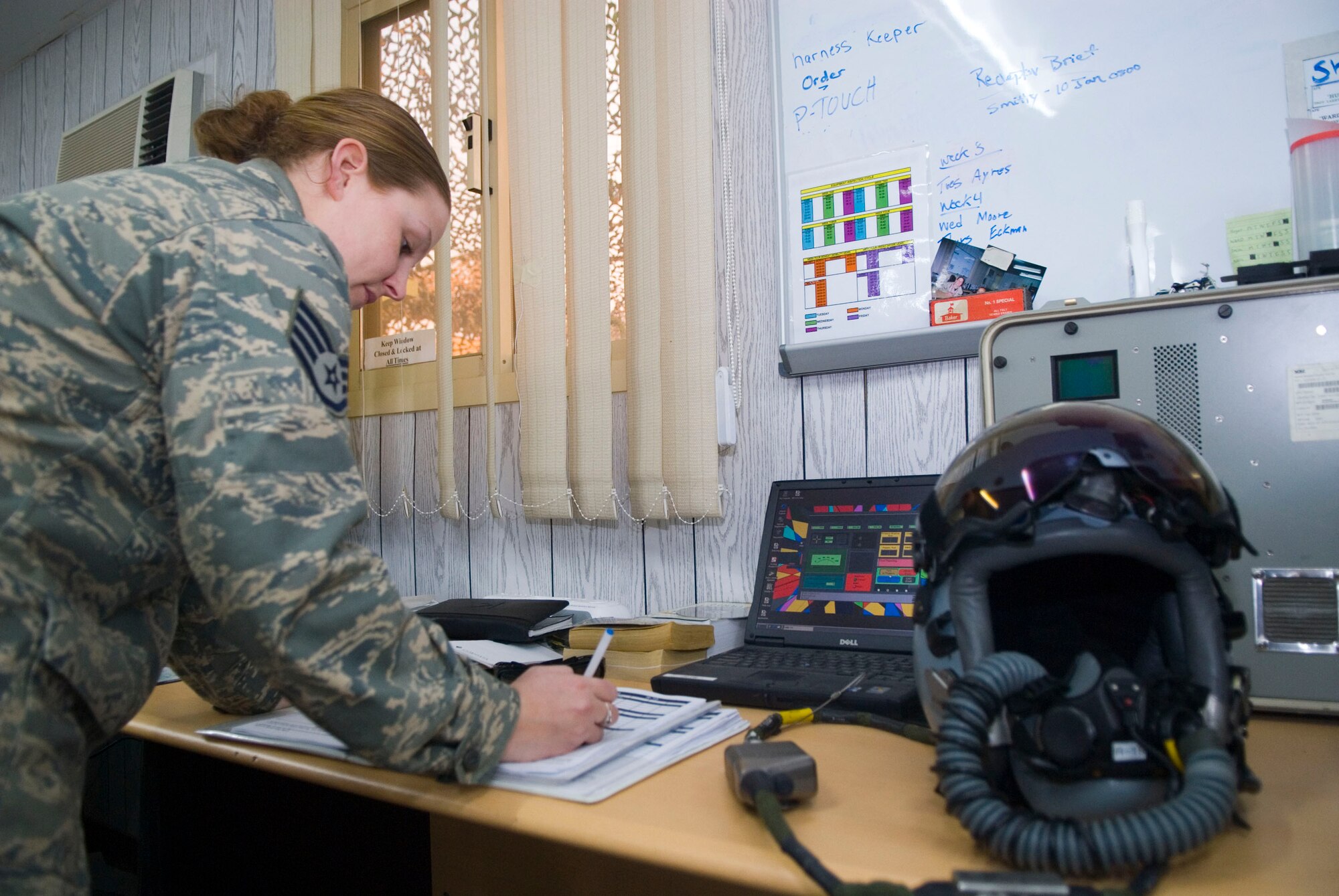 BALAD AIR BASE, Iraq -- Staff Sgt. Melissia Wells, a 22nd Expeditionary Fighter Squadron flight equipment technician, records the results from a Joint Helmet Cueing System pre-flight inspection. System is tested before and after every flight to ensure the display unit is functioning properly. Sergeant Wells is deployed from Spangdahlem Air Base, Germany. (Air Force photo/Staff Sgt. Joshua Garcia) 