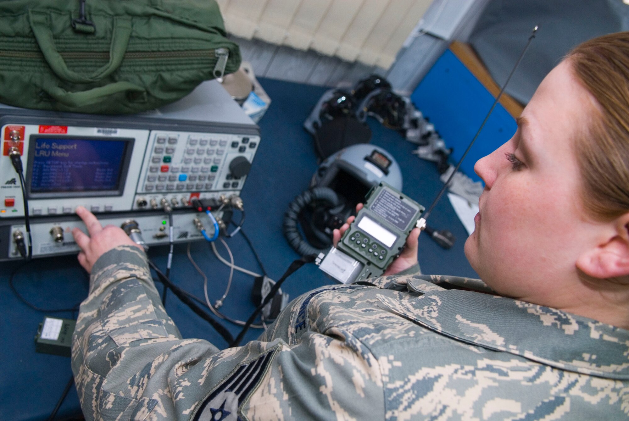 BALAD AIR BASE, Iraq -- Staff Sgt. Melissia Wells, a 22nd Expeditionary Fighter Squadron flight equipment technician, runs tests on a PRC-112B radio using a J-BOX radio tester. The test ensures the radio is properly sending and receiving radio frequencies. Sergeant Wells is deployed from Spangdahlem Air Base, Germany. (Air Force photo/Staff Sgt. Joshua Garcia) 