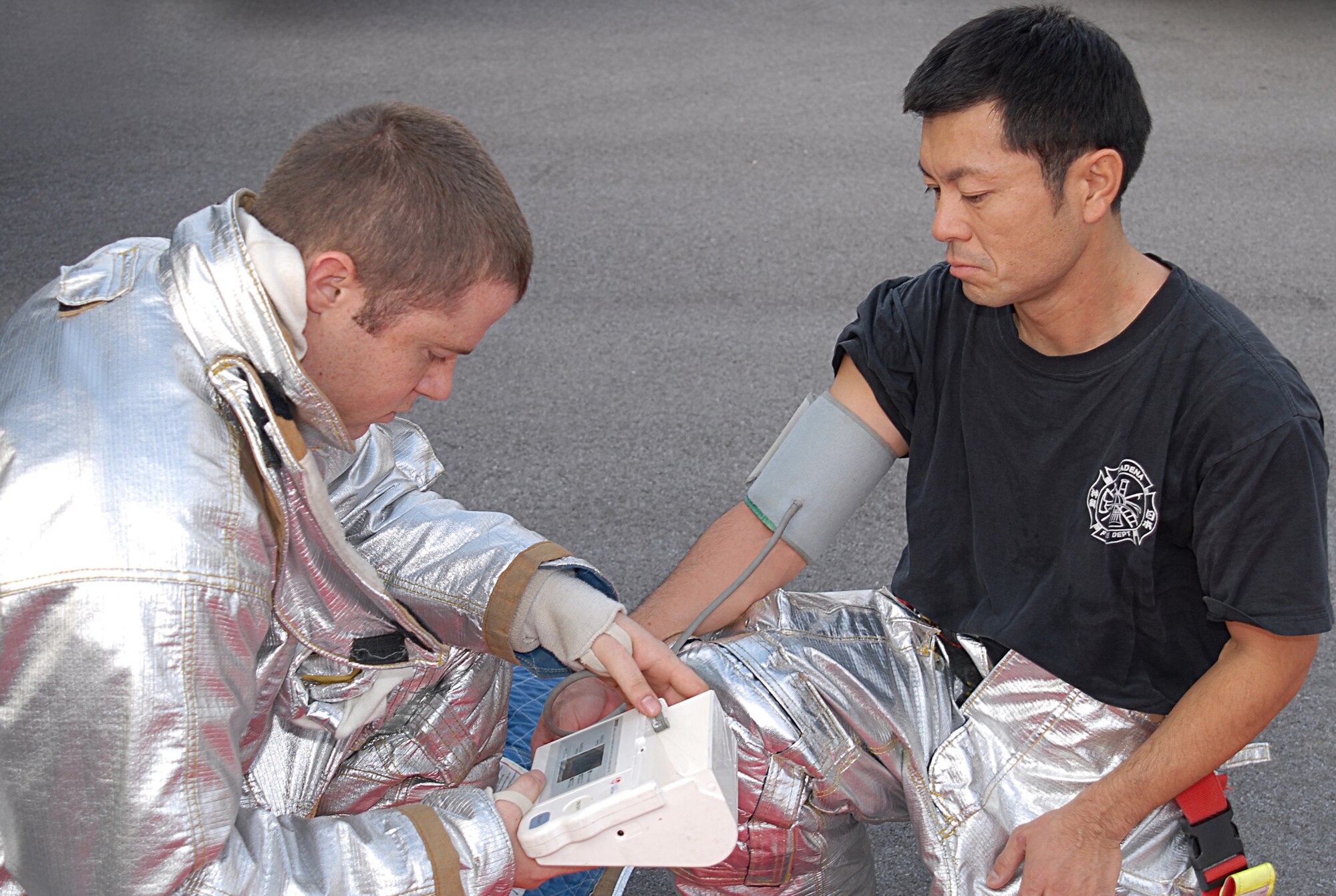 Airman 1st Class Anthony Fridley, 18th Civil Engineer Squadron, performs a blood pressure check on Mr. Tsuho Jitsuhito following a simulated fuel spill during Local Operational Readiness Exercise Beverly High 08-3 at Kadena Air Base, Japan, Jan. 7, 2007. The 18th Wing exercise from Jan. 7 to 11 tests the wing's ability to respond in contingency situations. (U.S. Air Force photo/Tech Sgt. Dave DeRemer)