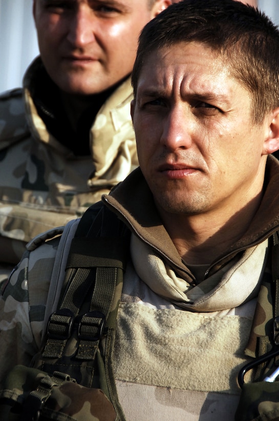A Polish army soldier listens to a convoy brief on Camp Echo, Iraq, Dec. 30, 2007, prior to a mission in Diwaniyah, Iraq.