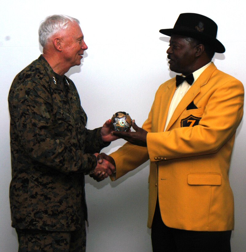 Lt. Gen. Jack Bergman, Commander Marine Forces Reserve, receives a prized Zulu coconut throw from Frank Boutte, King Zulu 2008. The Zulu Social Aid and Pleasure Club visited MarForRes, giving Marines insight into Mardi Gras history and culture.