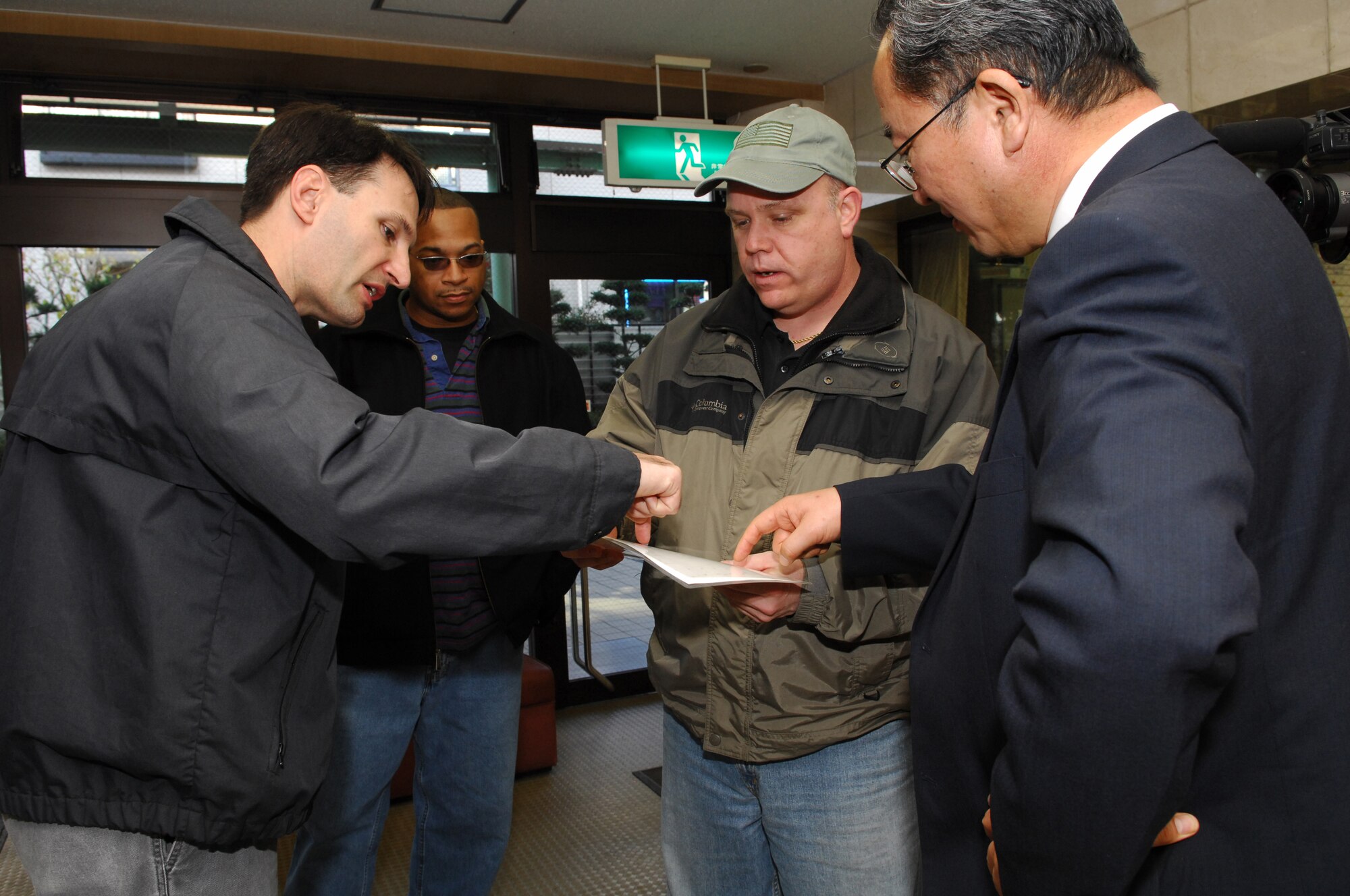 YOKOTA AIR BASE, JAPAN - Special Agent Eric M. O'Keeke (centre, The Air Force Office of Special Investigation(AFOSI) 6th Field Investigation Squadron) coordinates the cleaning plan of the Yokota Home, a retirement home, with Mr Abe Masao (Right, 374th Airlift Wing/Public Affairs). The AFOSI visited the home and cleaned the facility on 08/Jan/2008. (U.S.Air Force photo by Osakabe Yasuo)