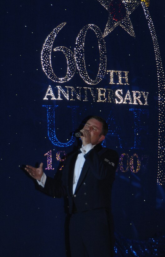 Senior Airman Nicholas Amari sings an Air Force classic, "Proud To Be An American," as one of the closing performances for the evening. There were approximately 800 family and service members that attended the event Jan.3. (U.S. Air Force photo/Senior Airman Sonya Padilla)