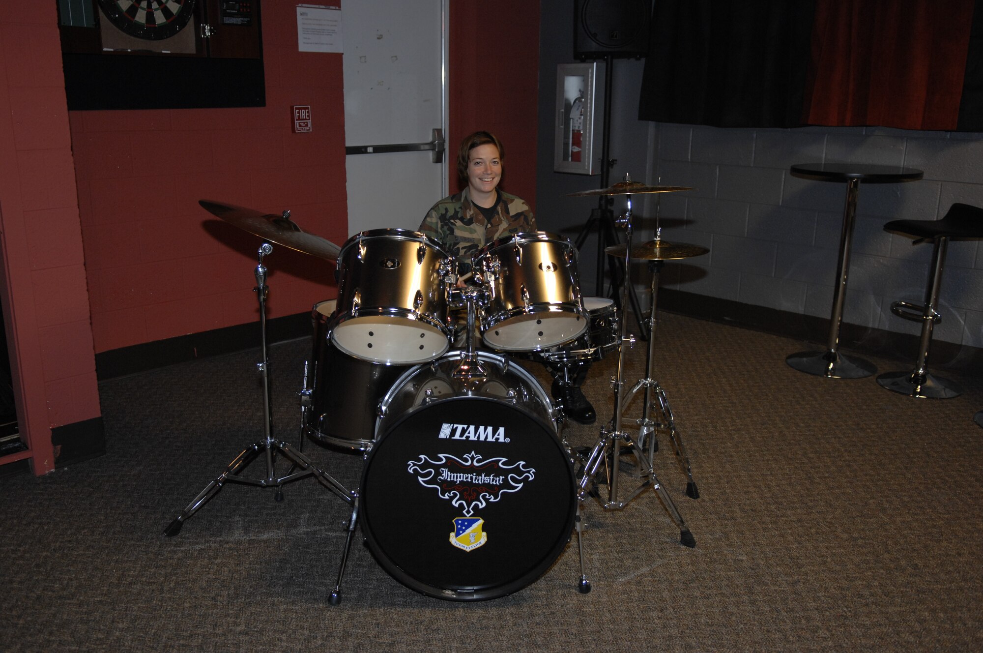 Airman First Class Katerina Slivinske, 49th Fighter Wing Public Affairs, shows her drumming skills at the Airman's Activity Center, Holloman Air Force Base, N.M. The newly renovated Airman's Activity Center offers a place for Airmen to interact with peers and enjoy themselves. (U.S. Air Force photo/Airman 1st Class Rachel A. Kocin)
