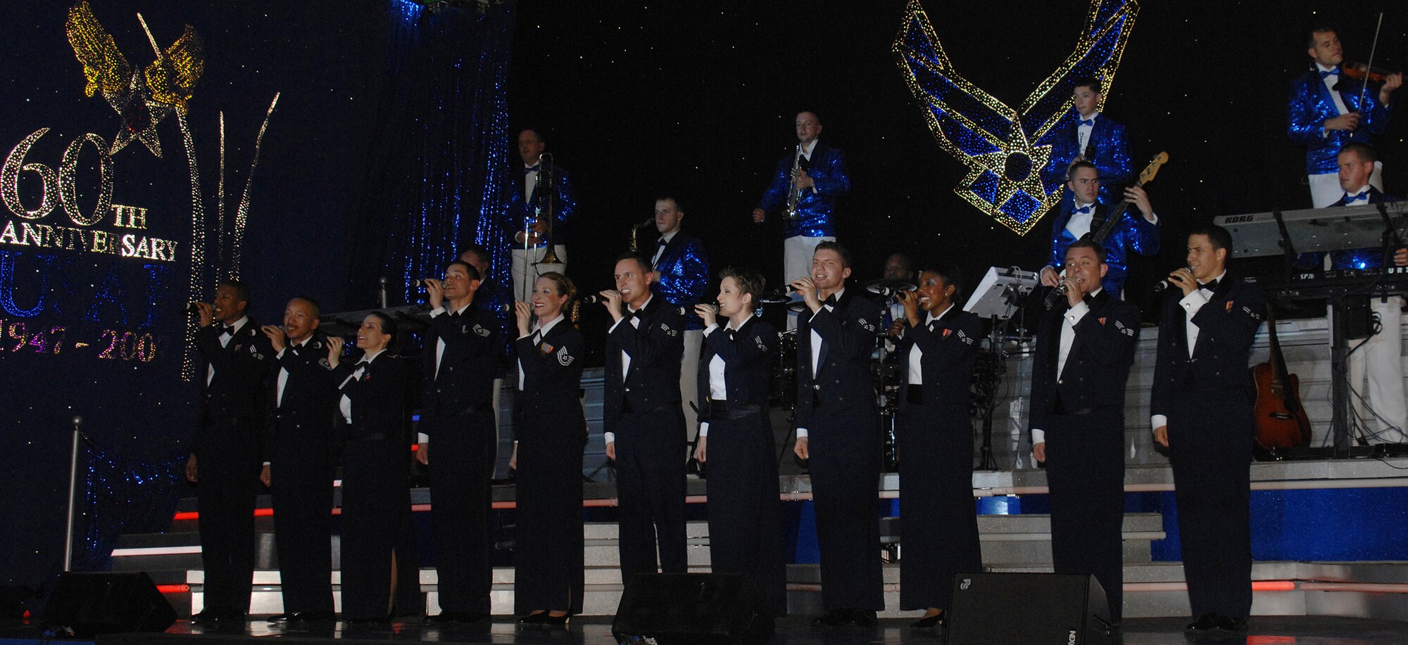 Members of Tops In Blue close out the night's performance with the singing of the Air Force song Jan.3. The performance was held from 7 to 9 p.m in Hangar 2 here. (U.S. Air Force photo/Senior Airman Sonya Padilla)