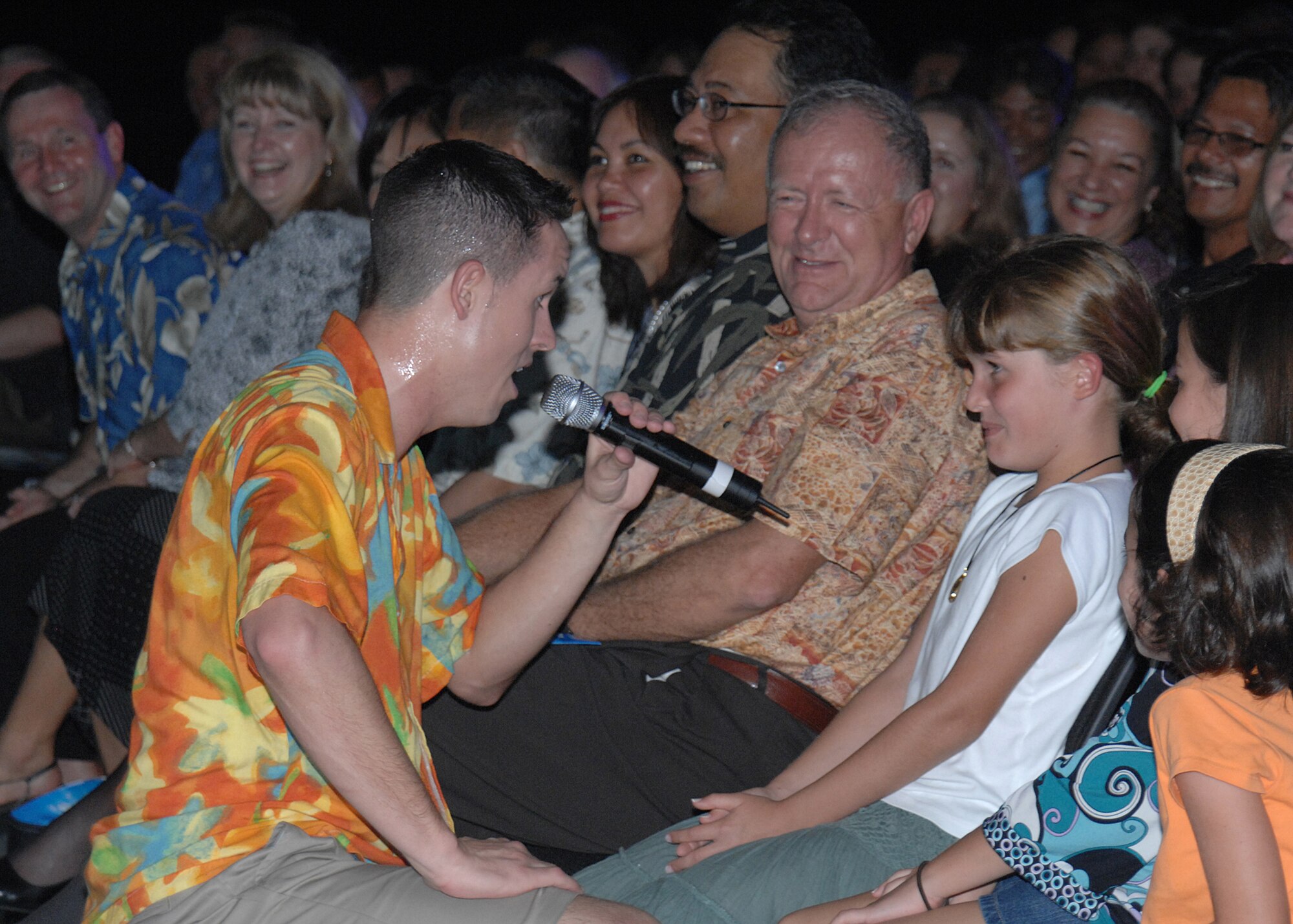 Senior Airman Benjamin Taylor sings to a young girl in the audience during the Tops In Blue performance here Jan. 3. (U.S. Air Force photo/Senior Airman Sonya Padilla)