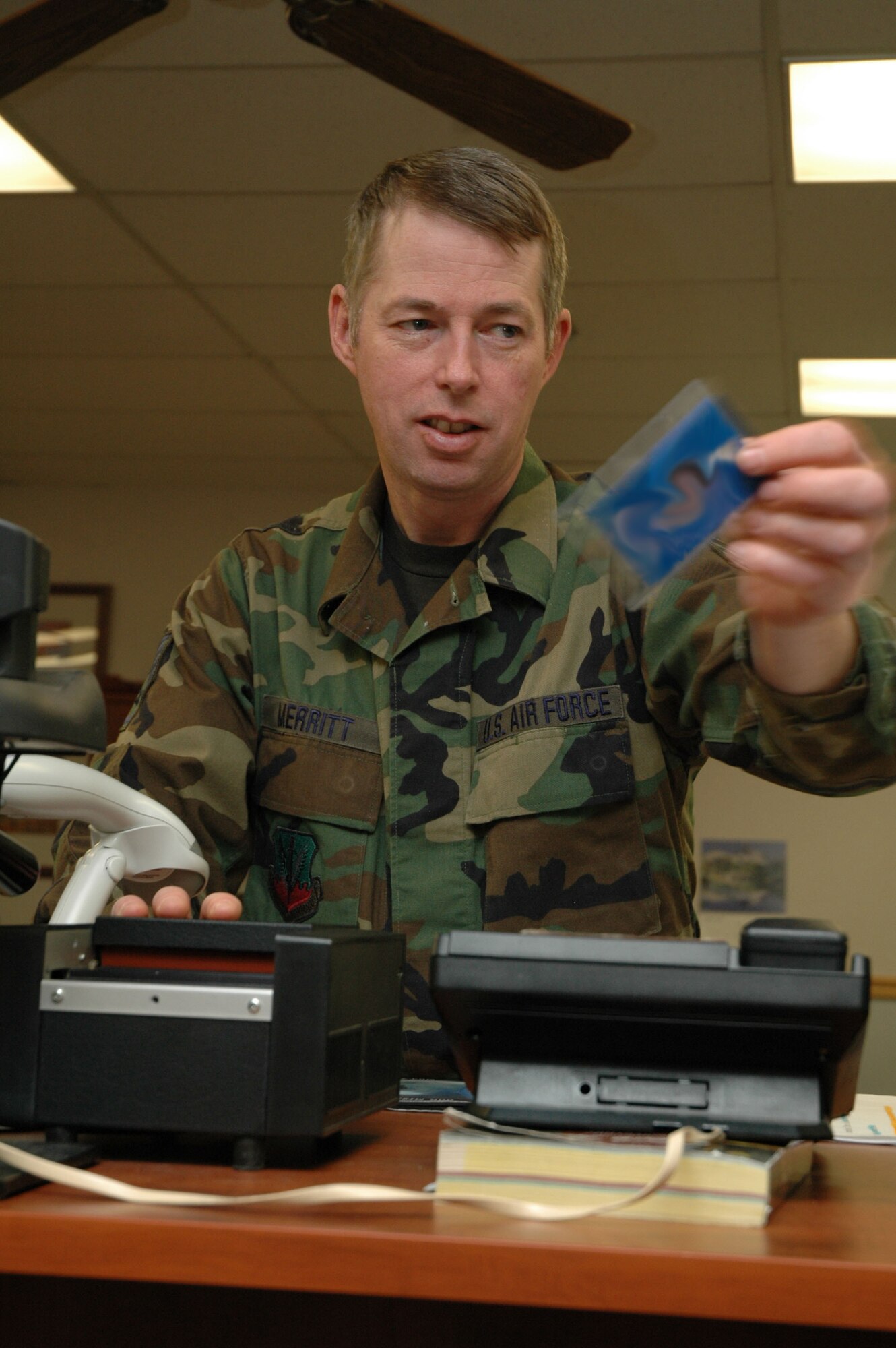 Staff Sgt. Charles Merritt, 341st Mission Support Squadron NCOIC of customer service, laminates an exercise-evaluation-team identification card Jan. 8. (U.S. Air Force photo/Airman 1st Class Dillon White)