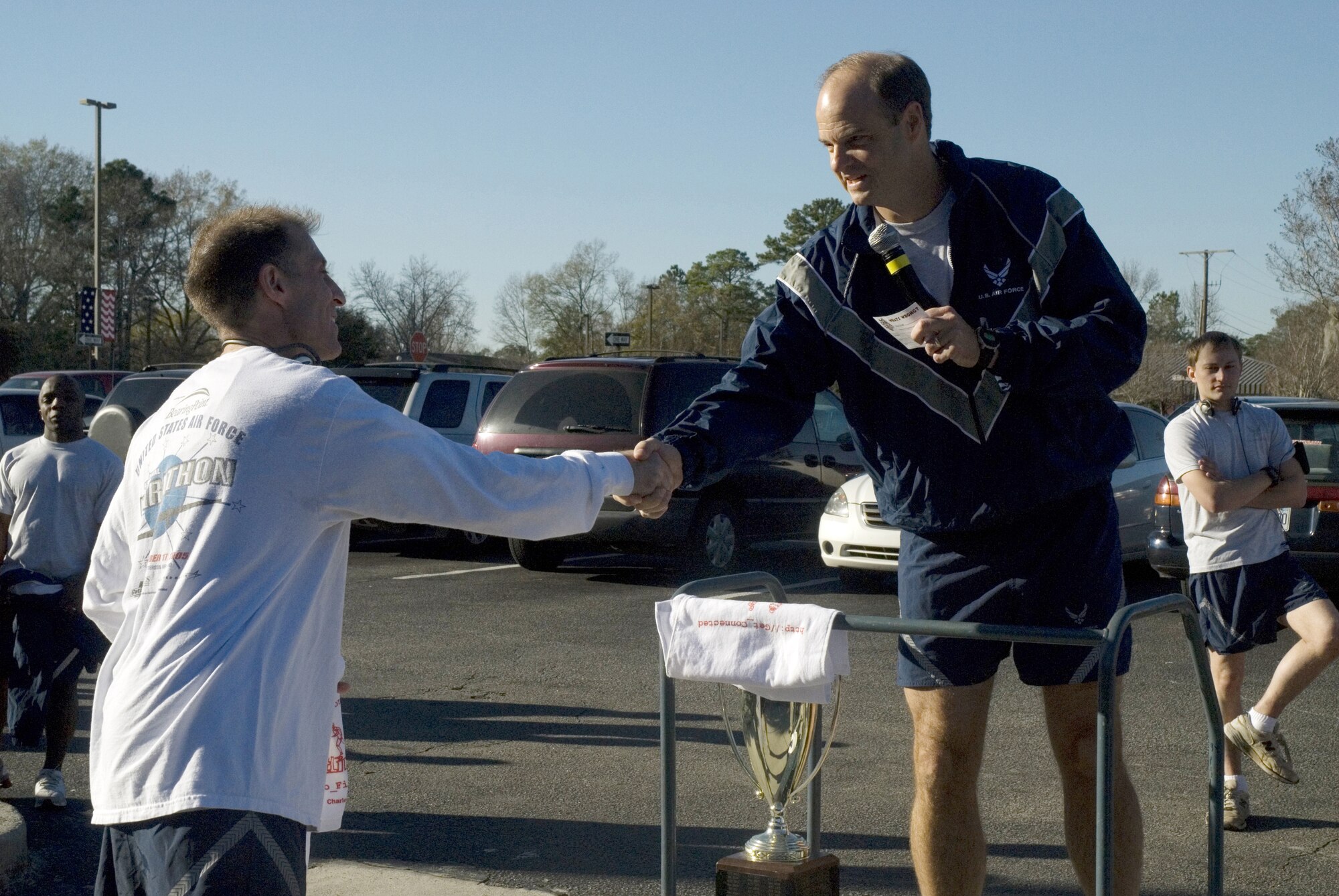 Tech. Sgt. Mike Bunting, 315th Maintenance Squadron, accepts congratulations from Col. Frank Fields, 437th Operations Group commander, for being the fastest male in this month's Commander's Challenge Run Jan 4. (U.S. Air Force photo/Staff Sgt. Jennifer Arredondo)
 
