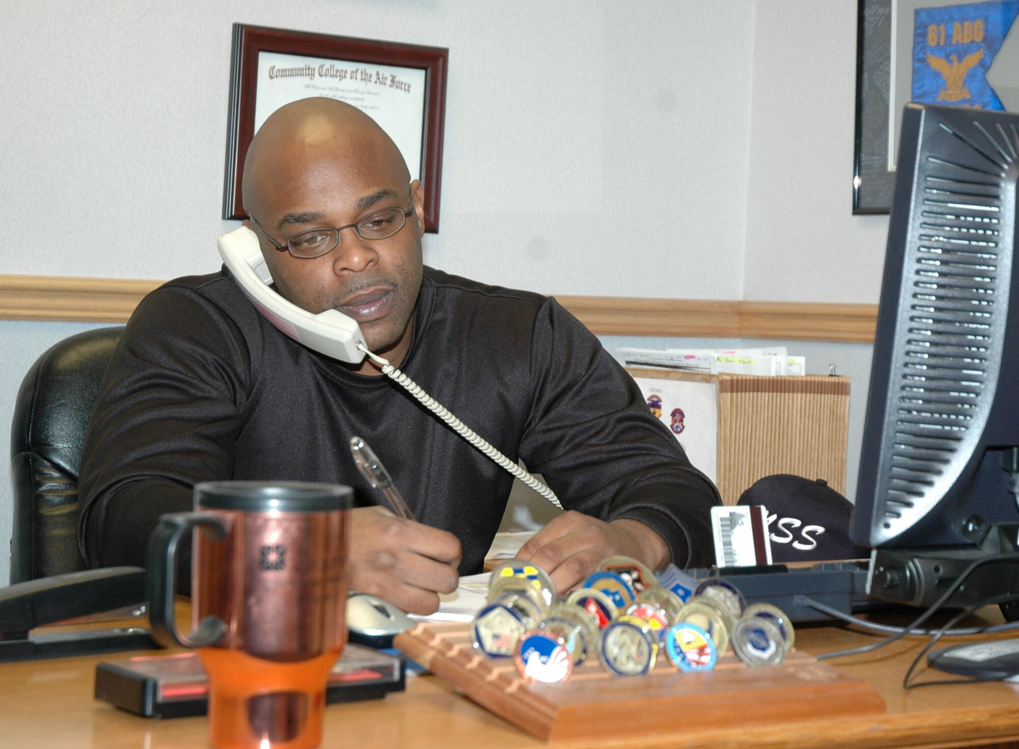 Staff Sgt. Corey Sales, 341st Mission Support Squadron military personnel element transactional management supervisor, answers his phone Jan. 7. Sergeant Sales transferred from the 341st Mission Support Group commander support staff, and is now a member of the transactional management office. (U.S. Air Force photo/Airman 1st Class Dillon White)  
