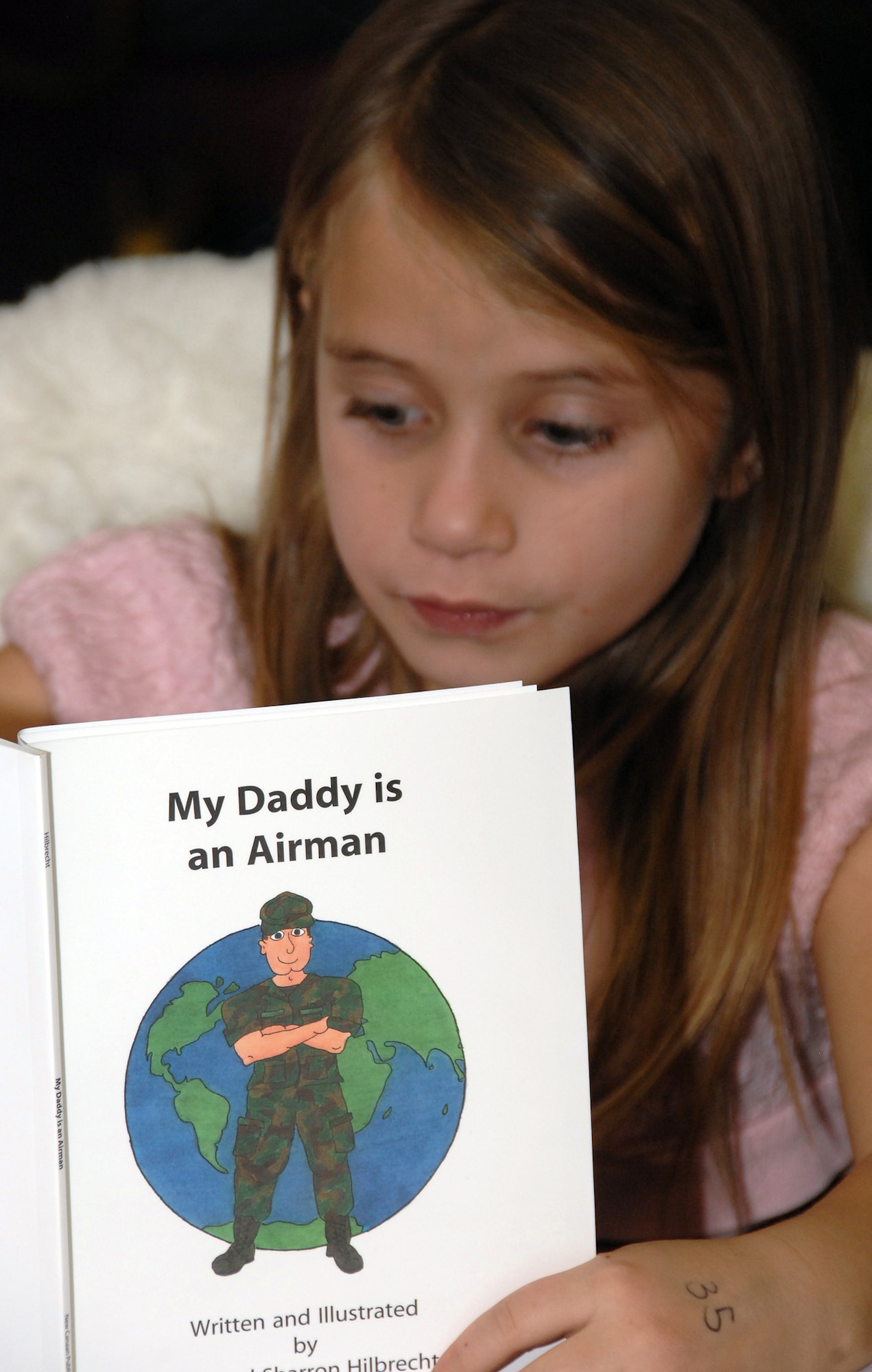 A child of a deployed Airman reads her “deployed family’s manual’ during the Combined Peterson/Schriever AFB Deployed Families Dinner Jan. 4. More than 200 family members attended the monthly event, breaking all previous attendance records. (U.S. Air Force photo/Duncan Wood) 
