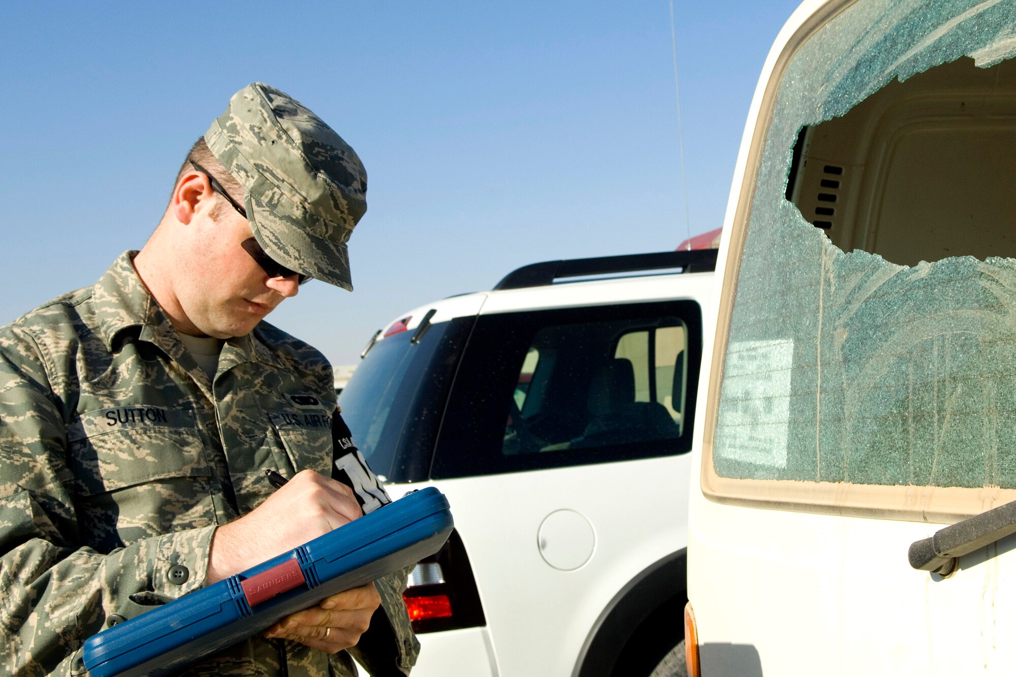Airman 1st Class Brandon Sutton takes notes at the scene of a property damage incident at one of the dining facilities Dec. 27 at Balad Air Base, Iraq. Airman Sutton is a 332nd Expeditionary Security Forces Squadron Det. 1 Provost Marshal Office patrolman and deployed from McConnell Air Force Base, Kan. (U.S. Air Force photo/Staff Sgt. Travis Edwards) 
