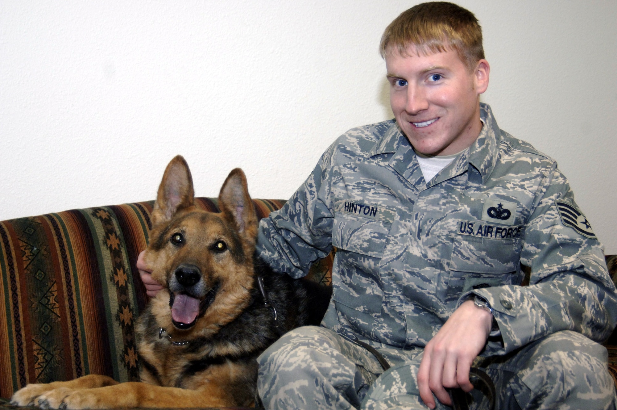 MOUNTAIN HOME AIR FORCE BASE, Idaho -- Astor, 366th Security Forces MWD and his handler Staff Sgt. Heath Hinton, 366th SFS MWD handler, relax inside the kennels after a day of work. Astor and Sergeant Hinton will make the transition from MWD and handler to pet and owner when Astor retires after serving with the 366th SFS’s Gunslingers since 1999 as a patrol certified and explosives detecting certified MWD (U.S. Air Force photo/ Senior Airman Megan P. Lyon)
