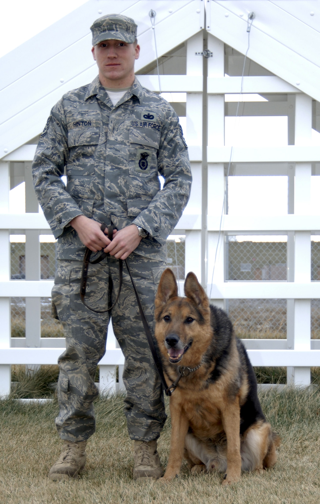 MOUNTAIN HOME AIR FORCE BASE, Idaho -- Astor, 366th Security Forces MWD runs down a set of steps while guided by his handler Staff Sgt. Heath Hinton, 366th SFS MWD handler, at the WMD kennels exercise area. Astor and Sergeant Hinton will make the transition from MWD and handler to pet and owner when Astor retires after serving with the 366th SFS’s Gunslingers since 1999 as a patrol certified and explosives detecting certified MWD (U.S. Air Force photo/ Senior Airman Megan P. Lyon)
