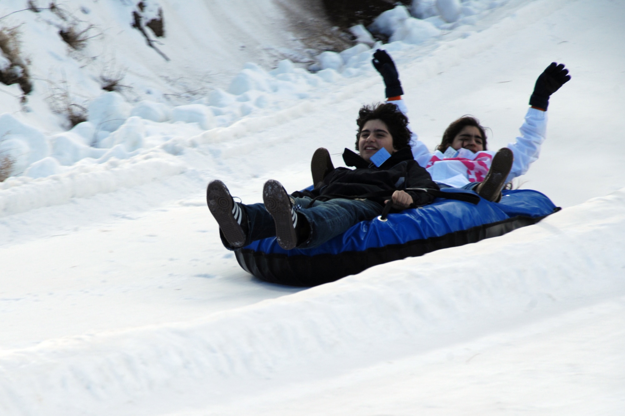 Members of the Ruidoso community enjoy a ride downhill at a Ruidoso winter park. The park offers exslusively designed tubes for three to six riders and super size tubes for three to 10 riders. (U.S. Air Force photo/Airman 1st Class Jamal D. Sutter)