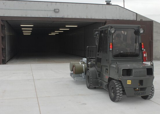 WHITEMAN AIR FORCE BASE, Mo. –Airman 1st Class Charles Braun, 509th Munitions Squadron, moves two BLU-109 Penetrater bombs to the new igloo Jan. 7. The new igloos feature wider entry ways allowing more maneuverability for forklifts. (U.S. Air Force photo/Tech. Sgt. Samuel A. Park)
