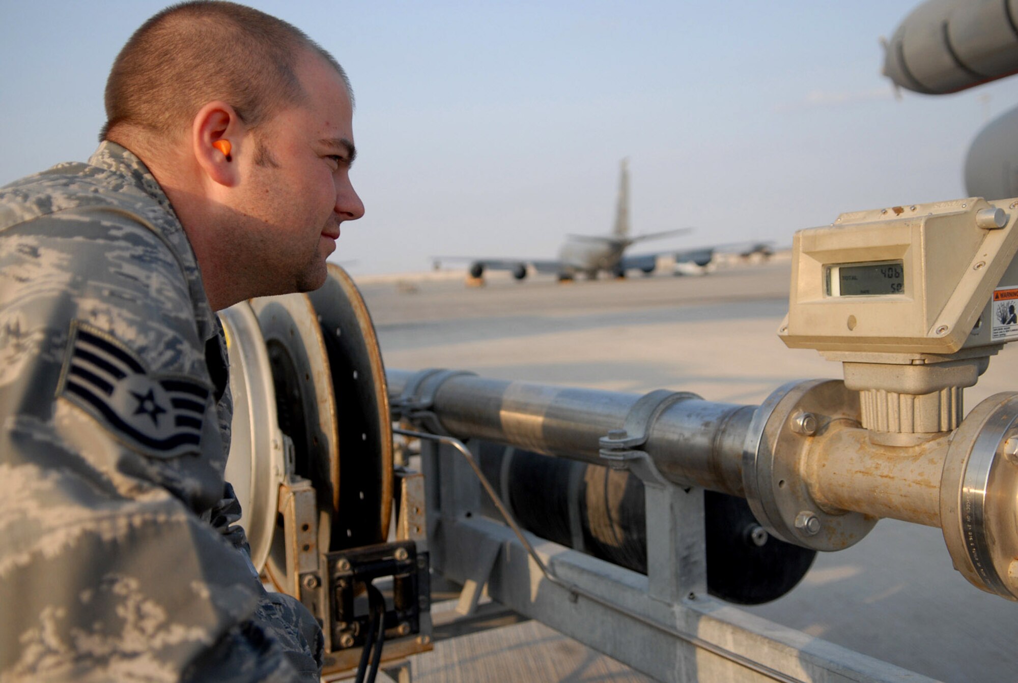 Staff Sgt. Mike Allen monitors the fuel delivered during a refueling operation Jan. 5 of a KC-135 Stratotanker at a Southwest Asia air base. Sergeant Allen is with the 379th Expeditionary Logistics Readiness Squadron and is deployed from Luke AFB, Ariz. His hometown is in Phoenix, Ariz. (U. S. Air Force photo/Staff Sgt. Douglas Olsen) 