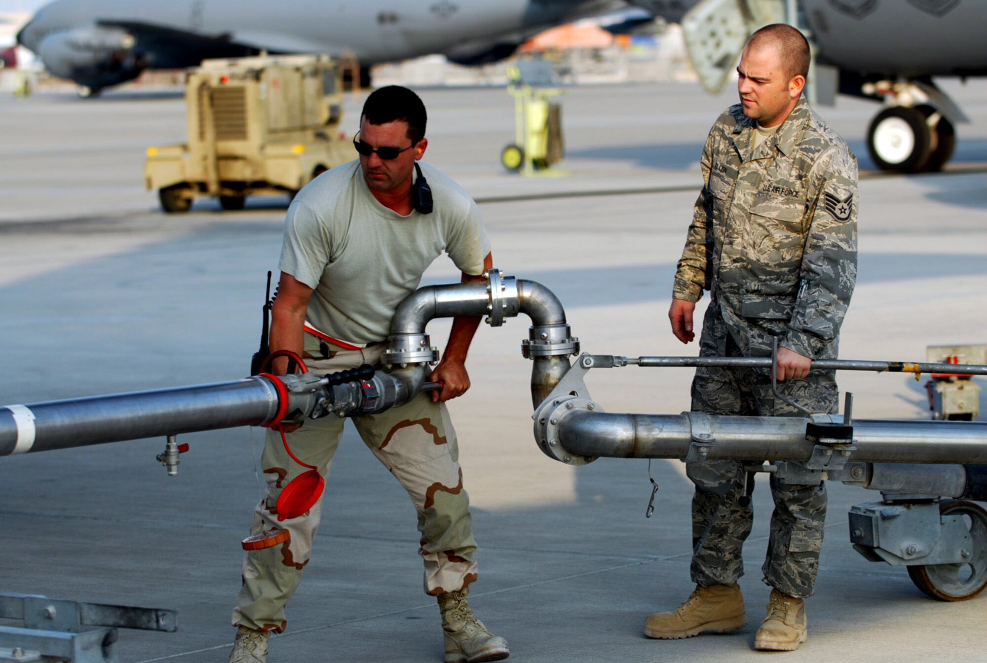 Staff Sgt. Brian McCaslin (left) and Staff Sgt. Mike Allen adjust the pantograph, a pipe system used to refuel a KC-135 Stratotanker, Jan. 5 at a Southwest Asia air base. Both Airmen are with the 379th Expeditionary Logistics Readiness Squadron. Sergeant McCaslin is deployed from Ebbing Air National Guard, Fort Smith Ark., and Sergeant Allen is deployed from Luke Air Force Base, Ariz. (U. S. Air Force photo/Staff Sgt. Douglas Olsen)