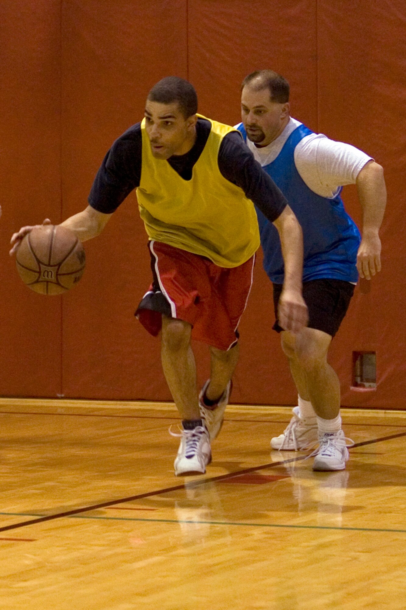 GRISSOM AIR RESERVE BASE, Ind.-- Brandon Williams, left, 434th Logistics Readiness Squadron, moves past Daniel Helms, a defender for the 434th Maintenance Squadron, during the annual 434th Services Flight basketball tournament at Grissom. LRS tightened up the screws on Maintainers with a score of 64-21. (U.S. Air Force photo/Senior Airman Omar Delacruz)