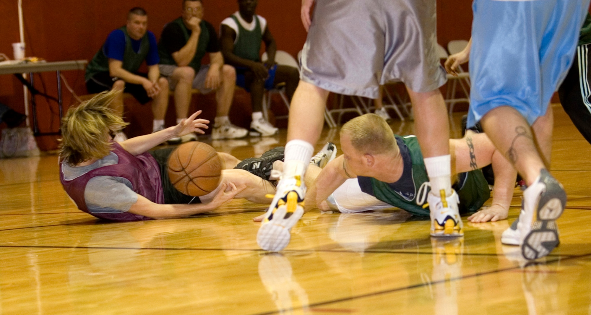 GRISSOM AIR RESERVE BASE, Ind. -- Kelly Kruger, Air Force Reserve Command services combat instructor, from Robins AFB, Ga., tries to maintain control of the ball after colliding with Sean Miller, 434th Security Forces Squadron, during the annual 434th Services Flight basketball tournament at Grissom. Minutes before the final buzzer, SVF managed to handcuff the Cops down the stretch to win the game 34-29 during opening round action. (U.S. Air Force photo/Senior Airman Omar Delacruz)