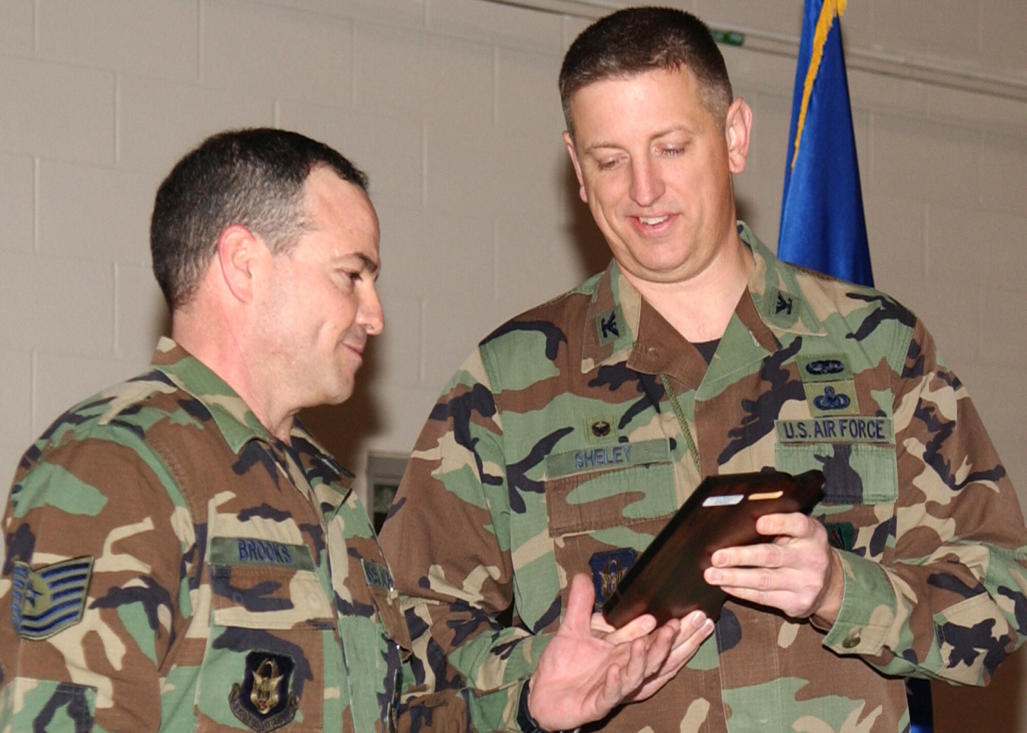 GRISSOM AIR RESERVE BASE, Ind., -- Col. Stan Sheley, 434th  Maintenance Group commander, right, presents Tech. Sgt Randy Brooks, an aircraft hydraulics systems craftsman, with a Top Three Performance Award during a MXG commanders call  held in January. (U.S. Air Force photo/Senior Airman Ben Mota)                 