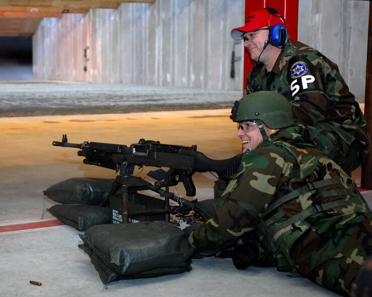 Colonel Earl Matthews, 435th Air Base Wing commander (left), and Tech. Sgt. Richard Solomon, 569th U.S. Forces Police Squadron Combat Arms Training and Maintenance instructor, look down the line of the refurbished CATM facility during a ribbon shooting where Colonel Mathews, Col. Neil Rader, and Lt. Col. Robert Roth used M240 machine guns to cut the ribbon signifying the opening of the new facility. (U.S. Air Force photo/Airman 1st Class Kenny Holston)