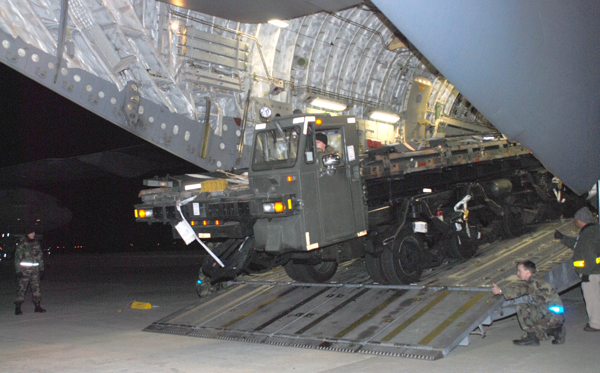 Airmen from the 305th Aerial Port Squadron here ring in the new year on the "Red Ball" Express, offloading a 60K Loader before uploading critical cargo destined for the AOR. The first flight of McGuire's newest mission departed shortly before midnight on New Year's Eve. (U.S. Air Force photo/Senior Airman Danielle Johnson)