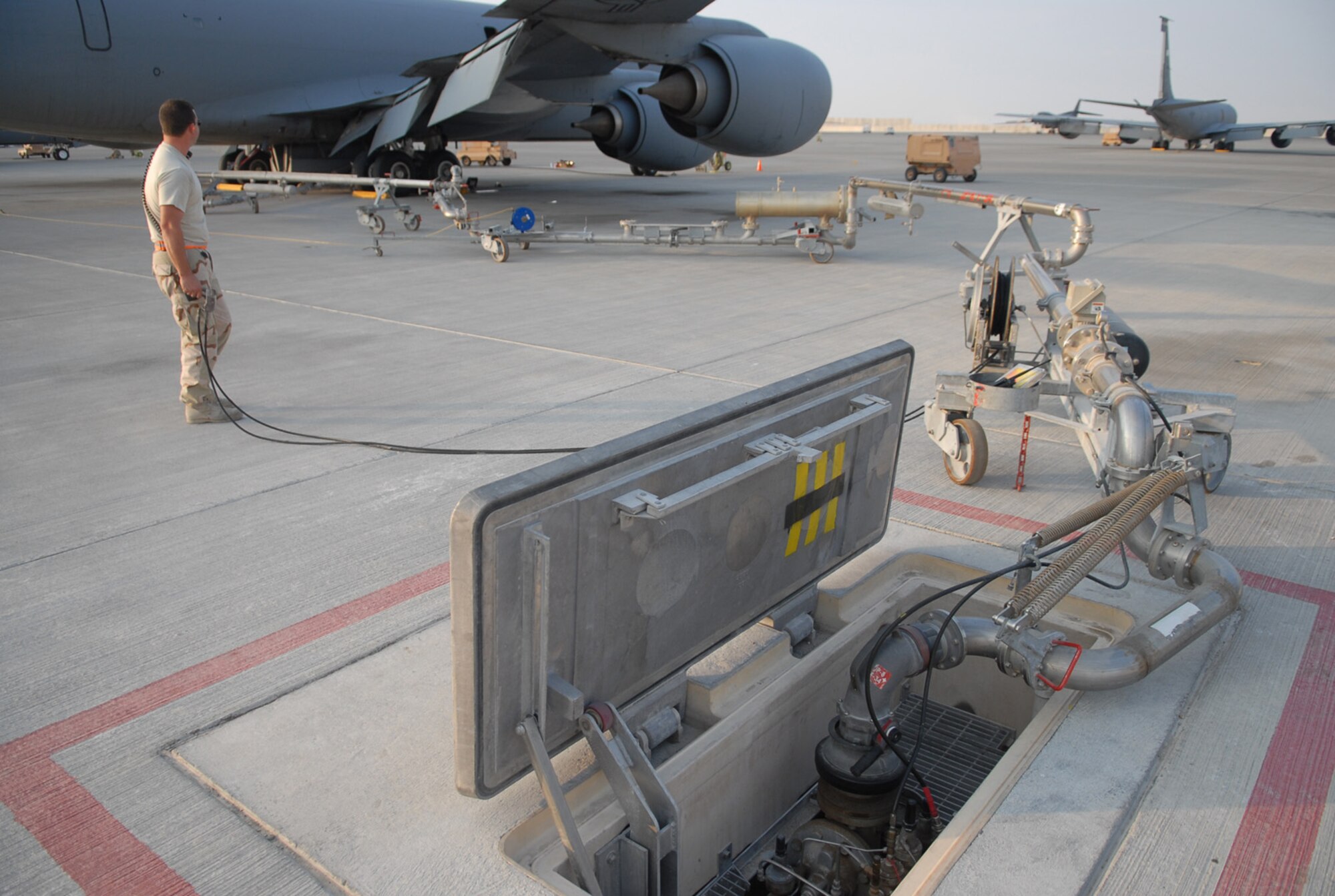 SOUTHWEST ASIA - Staff Sgt. Brian McCaslin, 379th Expeditionary Logistics Readiness Squadron, holds the dead-man switch during a refueling operation of a KC-135 Stratotanker at a Southwest Asia air base Jan. 5. Sergeant McCaslin is deployed from Ebbing Air National Guard, Ft. Smith Ark., and his hometown is Springdale, Ark. (U. S. Air Force photo/Staff Sgt. Douglas Olsen)