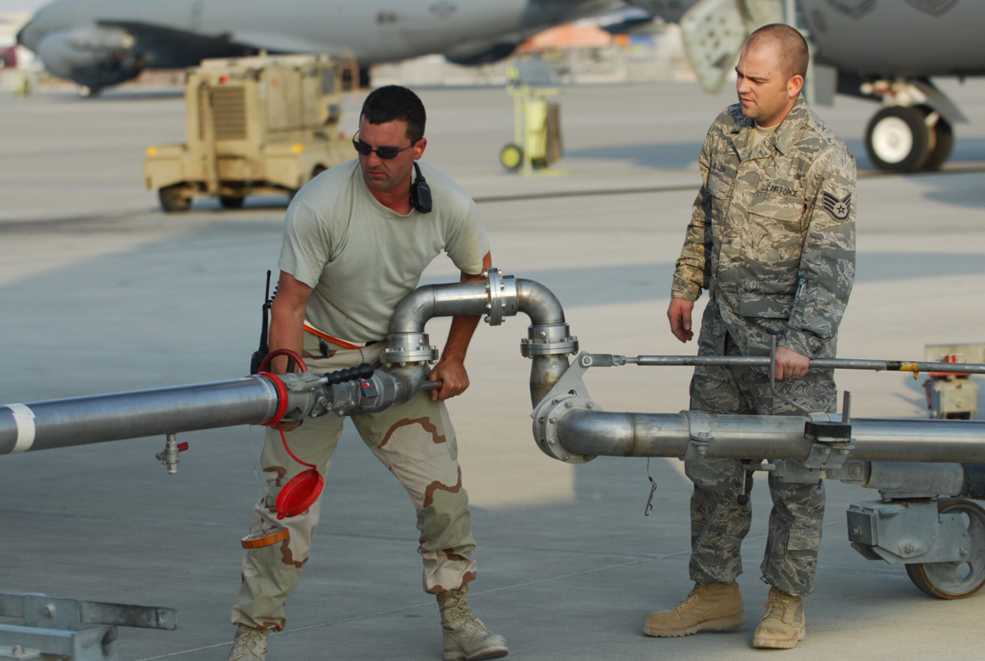 SOUTHWEST ASIA - Staff Sgt. Brian McCaslin (left), and Staff Sgt. Mike Allen, 379th Expeditionary Logistics Readiness Squadron, adjust the pantograph to refuel a KC-135 Stratotanker at a Southwest Asia air base Jan. 5. Sergeant McCaslin is deployed from Ebbing Air National Guard, Ft. Smith Ark., and Sergeant Allen is deployed from Luke AFB, Ariz. (U. S. Air Force photo/Staff Sgt. Douglas Olsen)