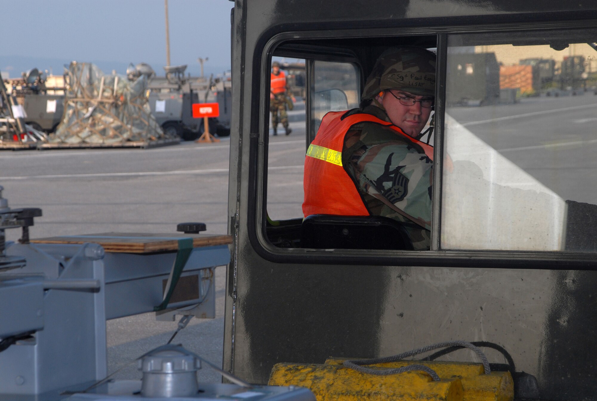 Staff Sgt. Paul Esquibel, 18th Logistical Readiness Squadron cargo team, backs up a tractor to move a pair of generators as part of a cargo load during Local Operational Readiness Exercise Beverly High 08-3 at Kadena Air Base, Japan, Jan. 7, 2007. The 18th Wing exercise from Jan. 7 to 11 tests the wing's ability to respond in contingency situations.    (U.S. Air Force photo/Staff Sgt. Christopher Marasky) 