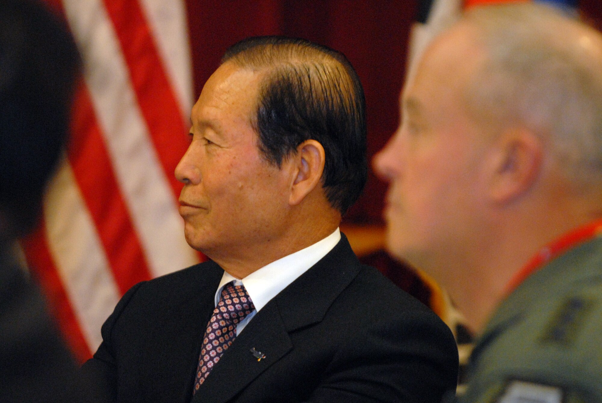 OSAN AIR BASE, South Korea -- Mayor of Gunsan City, Dong Shin Moon (left), and Lt. Gen. Stephen Wood, 7th Air Force Commander (right), listen to a speaker during lunch here Jan. 8.  The leadership of 7th Air Force hosted Gunsan civic leaders at Osan Air Base in support of the Good Neighbor Program where Kunsan Air Base is educating local civic leaders on the Air Force, 7th AF and 8th Fighter Wing missions while demonstrating how we work and train with our Korean allies to maintain peace and stability in the region. (U.S. Air Force photo/Senior Airman Steven R. Doty)