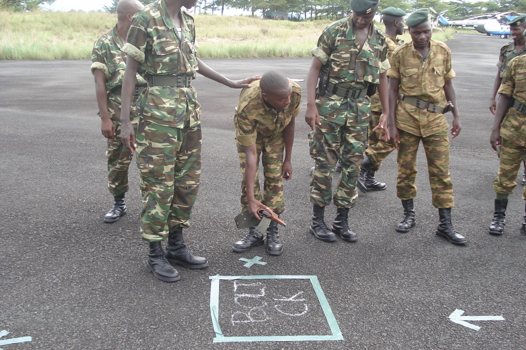A Burundi soldier learns how to set up a weapons check for fellow soldiers boarding Ugandan C-130 aircraft en route to Somalia. The 86th Contingency Response Group personnel trained the force throughout the month of December of 2007 for the country's first deployment outside the Burundi border. (Courtesy photo)