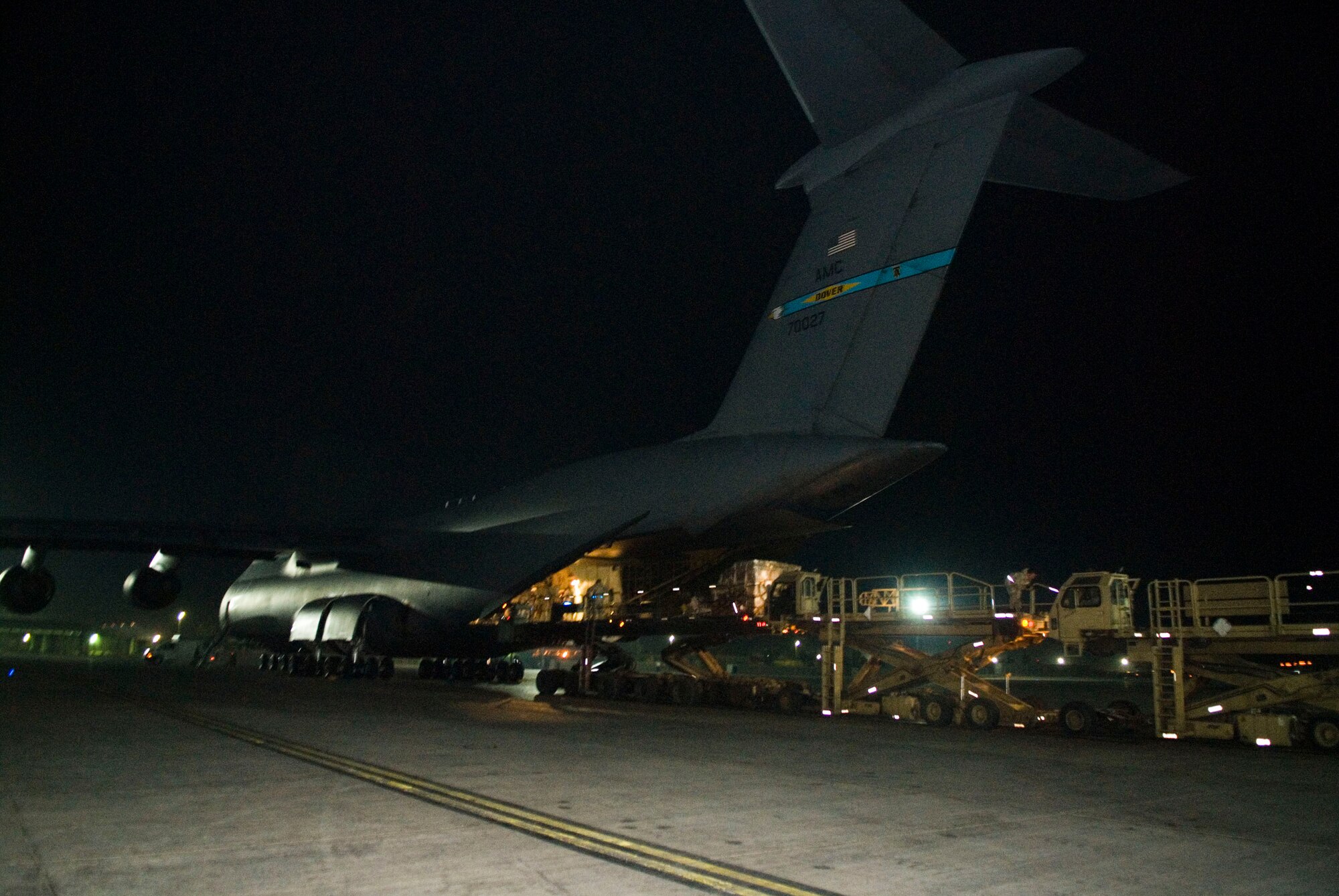 BALAD AIR BASE, Iraq -- A C-5 Galaxy is downloaded here, Jan. 7. The C-5 can hold a cargo load of 270,000 pounds, fly 2,150 nautical miles, offload, and fly to a second base 500 nautical miles away from the original destination without refueling. (U.S. Air Force photo/Staff Sgt. Joshua Garcia) 
