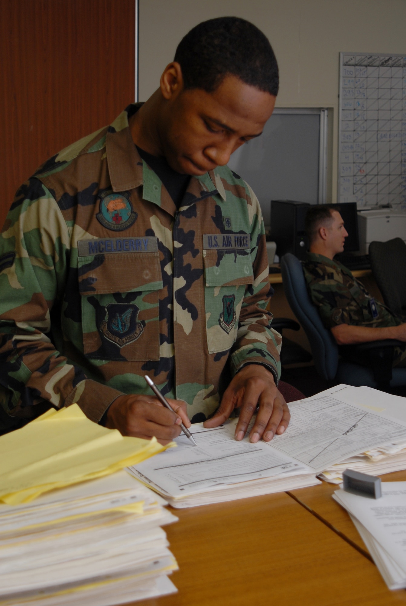 Airman 1st Class Chedric McElderry, 18th Aerospace Medical Squadron, prepares medical paperwork prior to personnel deployment processing during Local Operational Readiness Exercise Beverly High 08-3 at Kadena Air Base, Japan, Jan. 7, 2007. The 18th Wing exercise from Jan. 7 to 11 tests the wing's ability to respond in contingency situations. (U.S. Air Force photo/Tech. Sgt. Dave DeRemer)