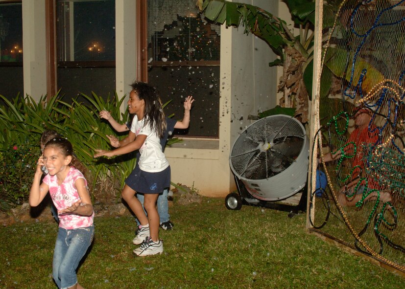 Children play in "fake snow" during Rota Walk Dec. 21. (U.S. Air force photo/Airman 1st Class Zachary Hunter)