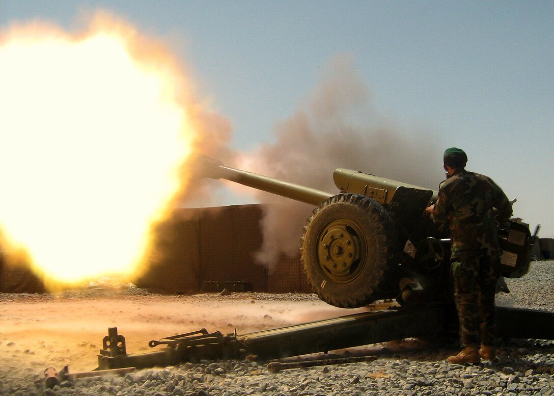 An artilleryman from the Afghan National Army's 205th Corps fires a round from a D-30 artillery piece during an indirect fire support mission, Sept. 9, 2007. For the past 10 months, U.S. embedded mentors have been helping train Afghans on Forward Operating Base Wolverine in Zabul province. 
