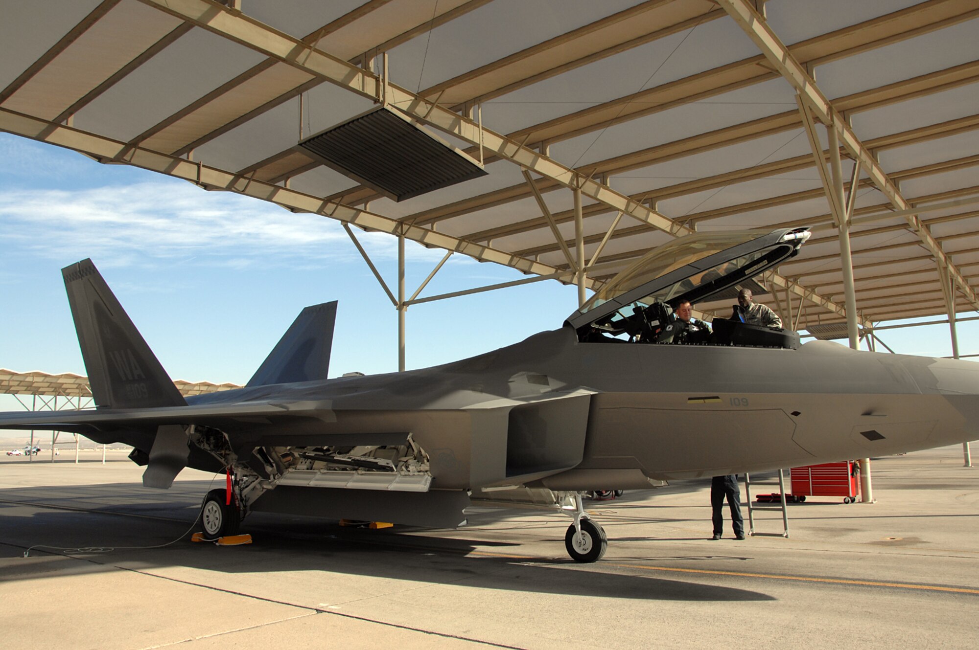 Maj. Micah Fesler, a 433rd Weapons School Student, prepares to exit an F-22A Raptor after a four-hour flight across the United States.  This Raptor is the first to be delivered to the 57th Wing from Lockheed-Martin, and is scheduled to be used by the Weapons School for training. (U.S. Air Force photo by Staff Sgt. Scottie McCord)