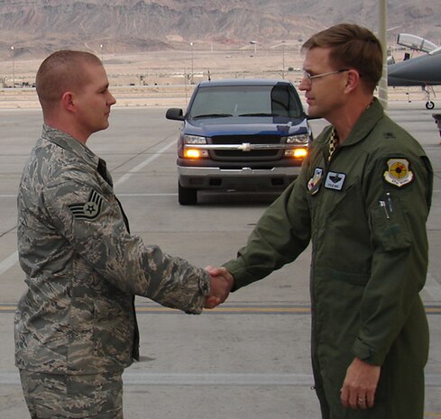 Newly promoted Tech. Sgt. Mathew Risse, a 57th Aircraft Maintenance Squadron flightline expediter, receives his official promotion from the 57th Wing commander, Brig. Gen. Stephen Hoog, as part of the Air Force’s Stripes for Exceptional Performer promotion program. (Courtesy photo from 57th Command Chief’s Office)
