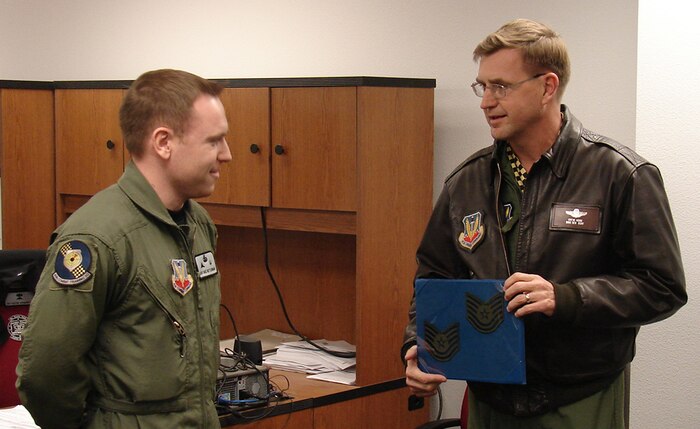 Newly promoted Tech. Sgt. Michael Nettleingham, a 414th Combat Training Squadron survival, evasion, resistance and escape specialist, receives his official promotion from the 57th Wing commander, Brig. Gen. Stephen Hoog, as part of the Air Force’s Stripes for Exceptional Performer promotion program. (Courtesy photo from 57th Command Chief’s Office)