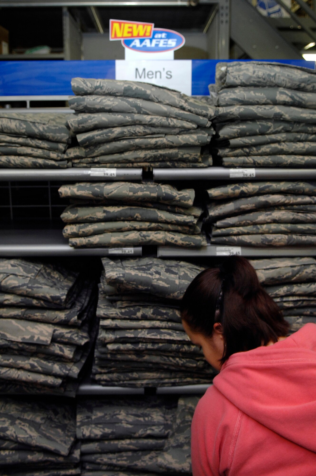 Celina Alamos, a worker for the Army and Air Force Exchange Service (AAFES) and wife of Airman 1st Class Jancey Alamos, from the 28th Security Forces Squadron, stocks shelves with new Airman Battle Uniforms (ABU) at Ellsworth Air Force Base, S.D., Jan. 09, 2008.  The ABU will be available for purchase to the general base population for the first time starting Friday at 9 A.M., for more information contact AAFES at 923-4774.  (U.S. Air Force photo/Staff Sgt. Michael B. Keller)