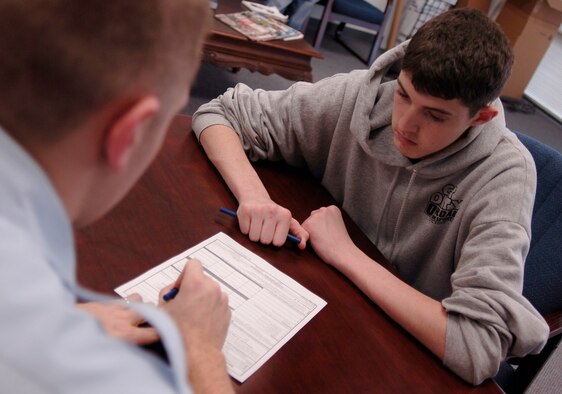 MCCONNELL AIR FORCE BASE, Kan. -- Elliot Snow reads the Non-prior Service statement before he takes the oath of enlistment, Dec. 21. This statement, among other documentation, is the last step before taking the oath of enlistment.  (Photo by Airman 1st Class Maria Ruiz)