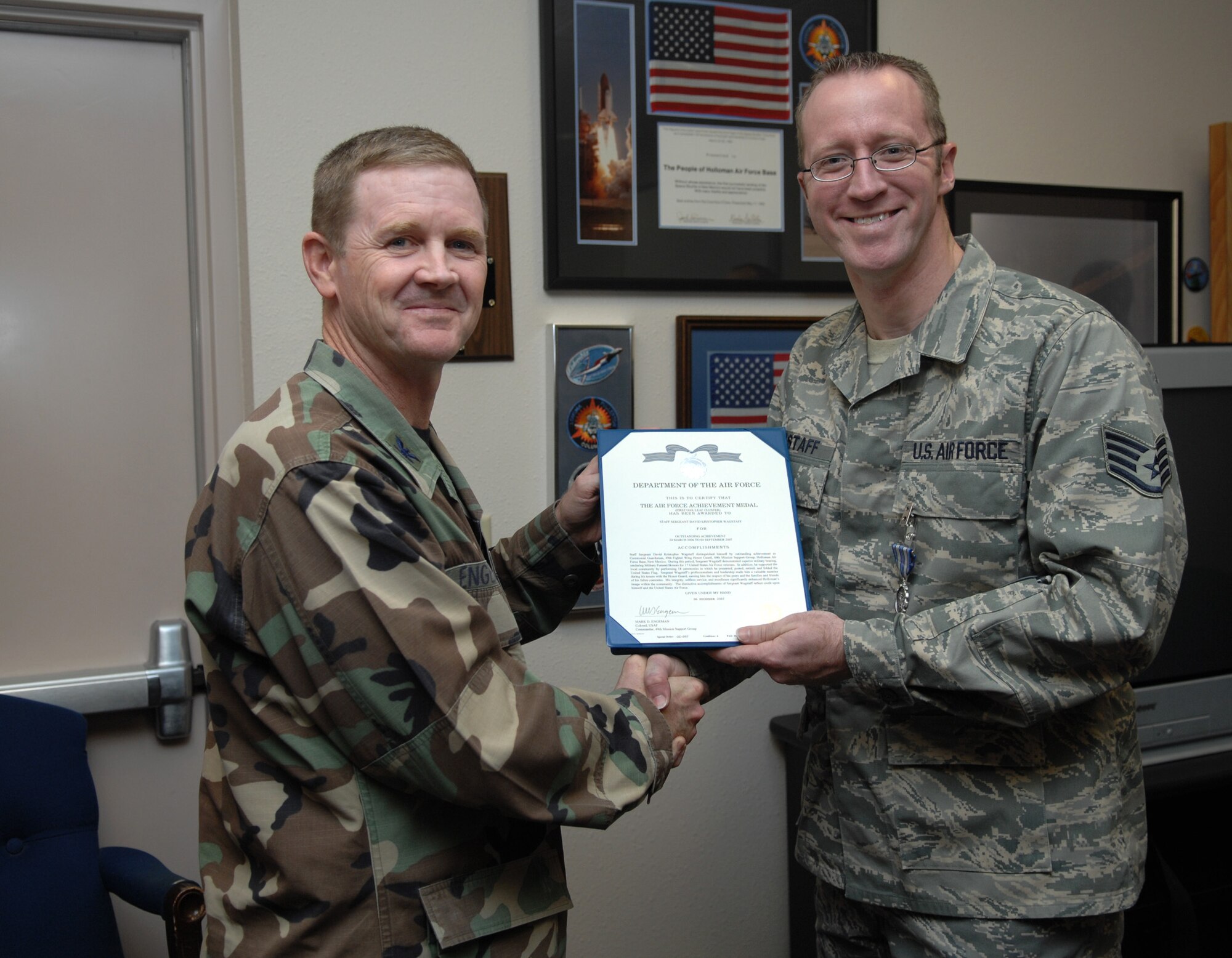 Col. Mark Engeman, 49th Mission Support Group commander, presents Staff Sgt. David Wagstaff, 49th Fighter Wing Public Affairs, with an Achievement Medal for his service to the Steel Talons Honor Guard. Medals are one of many incentives of being a part of the Steel Talons. The next training class is coming up in February. (U.S. Air Force photo/Senior Airman Heather Stanton)