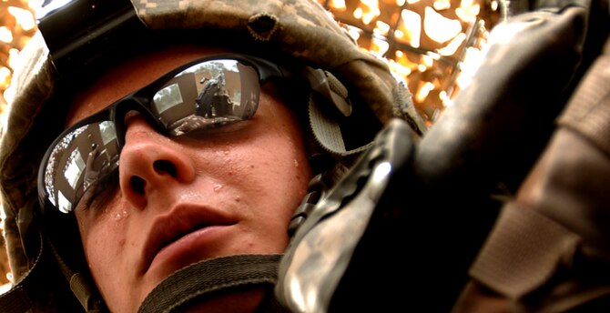 Senior Airman Ian Ramirez performs turret duty in 108 degree heat on an up-armored HUMVEE as part of a four vehicle convoy to Iraqi police stations in downtown Baghdad. He was part of the 732nd Expeditionary Security Forces whose mission was to perform as Police Transition Teams mentoring, coaching and teaching Iraqi police. Airman Ramirez, along with 14 other Malmstrom Airmen, volunteered for a 365-day deployment. Most of his teammates from the 341st Space Wing returned to Montana November 2007. (U.S. Air Force photo/Tech. Sgt. Cecilio M. Ricardo Jr.)