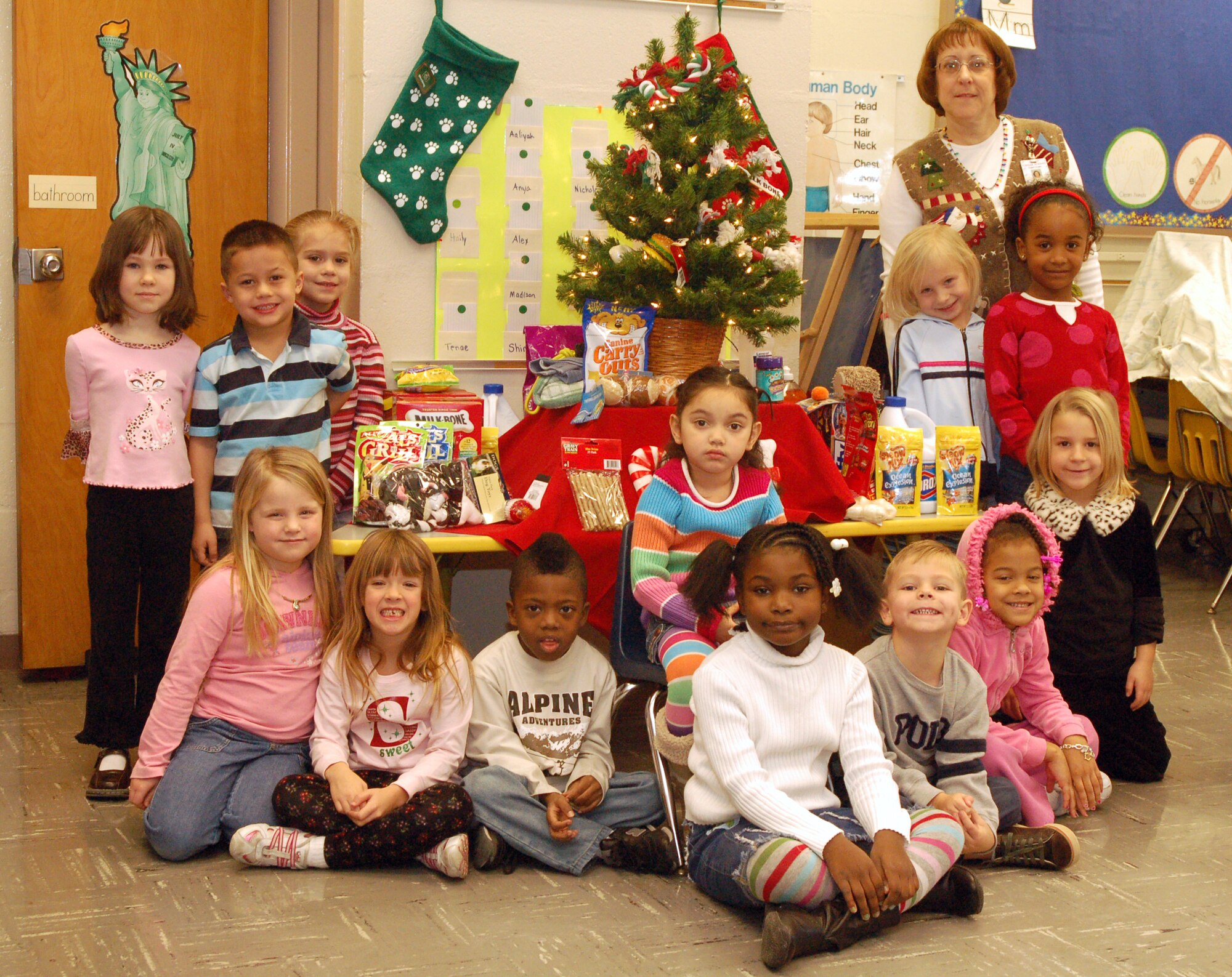 Cecilia Robinson's kindergarten class at the Major George Welch Elementary School poses in front of the Christmas tree with treats and items that were donated to the Kent Count Society for the Prevention of Cruelty to Animals.