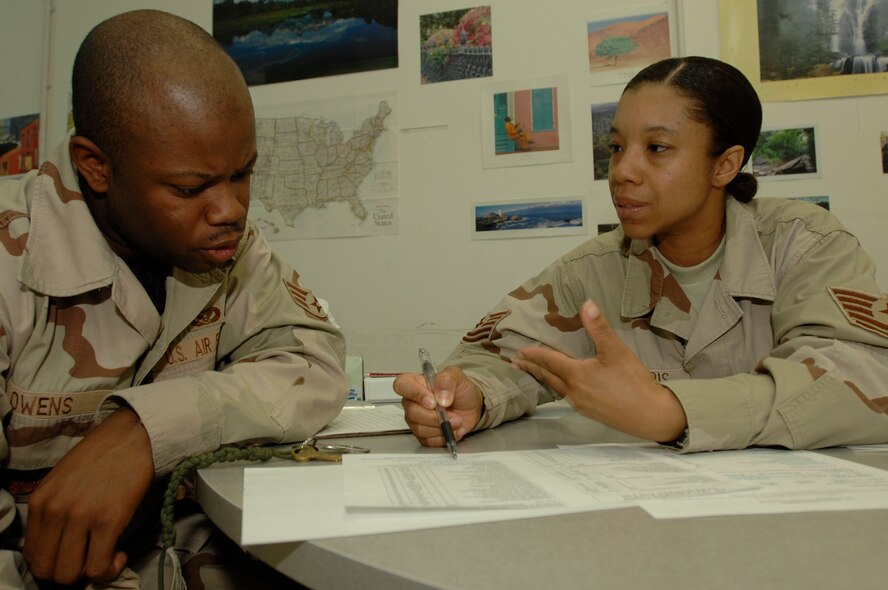 Tech. Sgt. Lisa Harris explains to Senior Airman Eric Owens all the College Level Examination Program tests available for him to take Jan. 3 at Ali Base, Iraq. The 407th Expeditionary Services Squadron Education Center gives servicemembers the opportunity to further their education and career development. Airman Owens is assigned to the 407th Expeditionary Civil Engineer Squadron and is deployed from Hickam Air Force Base, Hawaii. Sergeant Harris is assigned to the 407th Expeditionary Services Squadron and is deployed from Andrews AFB, Md. (U.S. Air Force photo/Airman 1st Class Jonathan Snyder) 