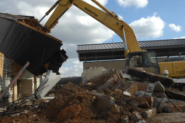 SHAW AIR FORCE BASE, S.C. -- Col. Francis Xavier, 20th Mission Support Group commander, makes the first devastating blow to the near 60-year-old building 200 which has become a fixture of the landscape here at Shaw AFB, January 7. The demolition process has begun and there are no immediate plans to build on the property. (U.S. Air Force Photo/Staff Sgt. Henry L. Hoegen Jr.)