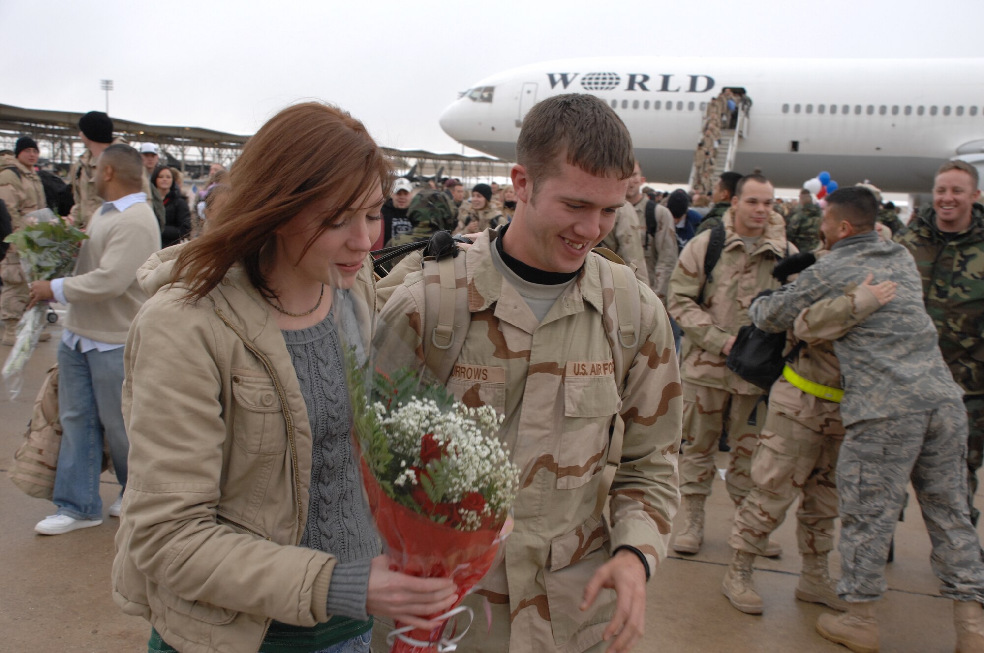 Staff Sgt. William Burrows, a 388th Aircraft Maintenance Squadron Airman, is greeted by a loved one at the 4th Fighter Squadron homecoming Jan. 8.  The 4th FS deployed to Balad Air Base, Iraq in August and flew approximately 1,800 missions in support of ground forces in Operation Iraqi Freedom.  (U.S. Air Force photo by Alex Lloyd)