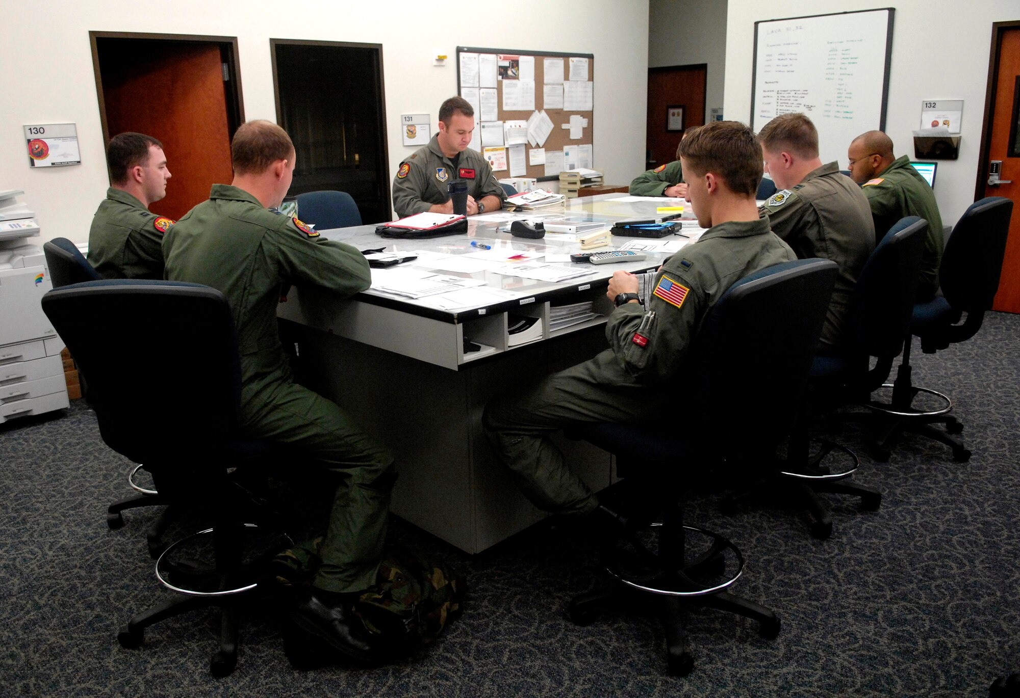 Aircrew members conduct a pre-flight briefing Jan. 7 at Hickam Air Force Base, Hawaii, before flying a local training mission on a C-17 Globemaster III. The Airmen are with the 535th Airlift Squadron. (U.S. Air Force photo/Tech. Sgt. Shane A. Cuomo) 